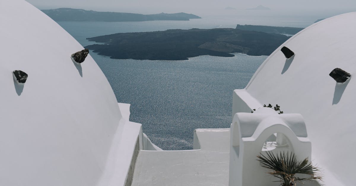 Serene view of Santorini's iconic white architecture against the deep blue Aegean Sea.