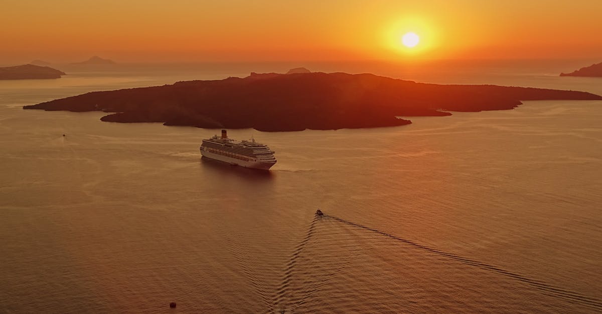 A breathtaking sunset view of a cruise ship near the island of Santorini, Greece.